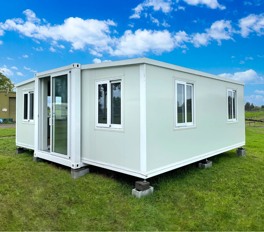 Modular building on grass with a blue sky and clouds